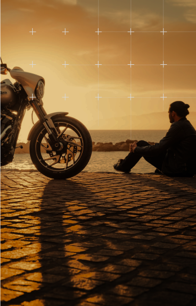 Person with motorcycle at sunset